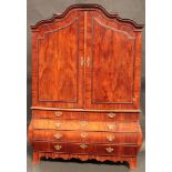 A large 19th century Dutch mahogany bombe shaped linen press, shaped arched cresting above a pair of