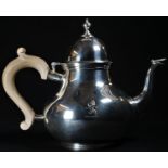 A George I style silver pear shaped teapot, hinged domed cover with knop finial, scroll-capped