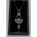 An Art Deco style diamond and natural saltwater pearl pendant necklace, shaped chandelier multi