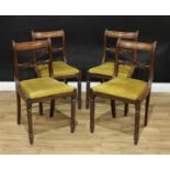 A set of four George IV mahogany bar back dining chairs, each central rail carved with a shell and