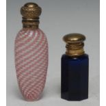 A 19th century lady's tapered fluted glass scent bottle, the interior in opaque tones of pink and