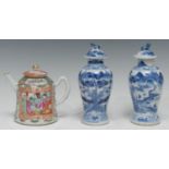 A pair of 19th century Chinese porcelain baluster vases and covers, painted in underglaze blue