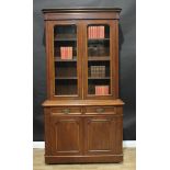 A Victorian walnut library bookcase, moulded outswept cornice above a pair of arched glazed doors,