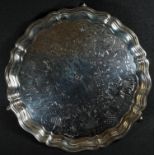 A Victorian silver salver, the field engraved with a broad band of leafy scrolls and diaper