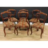 A set of six Victorian walnut dining chairs, cartouche shaped backs, stuffed-over seats, cabriole
