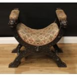 A Renaissance Revival oak X-framed window seat, stuffed over upholstery, carved with strapwork,