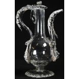 A Continental silver mounted clear glass ewer shaped oil bottle, hinged cover, stiff leaf