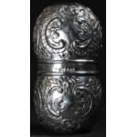 A 19th century silver double-beaker, chased with flowers and C-scrolls, parting to form a pair of