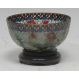 A Chinese plique a jour bowl, decorated in polychrome enamels wirth flowers, 7.5cm diam, hardwood