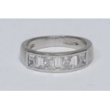 A diamond channel set eternity ring, crest inset with seven alternating rectangular cushion and