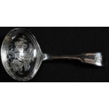 A George IV silver fiddle pattern caddy spoon, the oval bowl bright-cut engraved with ribbon-tied