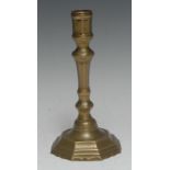 A late 17th century French brass octagonal candlestick, knopped stem, shaped base, 20cm high, c.1690
