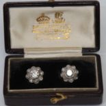 A pair of diamond floral cluster earrings, each with a central round brilliant cut collar set