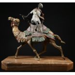 A large Austrian cold painted bronze, in the manner of Bergman, of an Arab warrior on a camel,