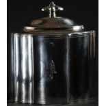 A George III silver commode shaped tea caddy, hinged domed cover with fluted knop finial, outlined