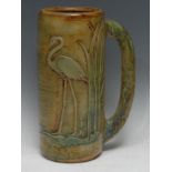 A Denby umbrella pot, in relief with a flamingo amongst bulrushes, in mottled green, 38cm high,