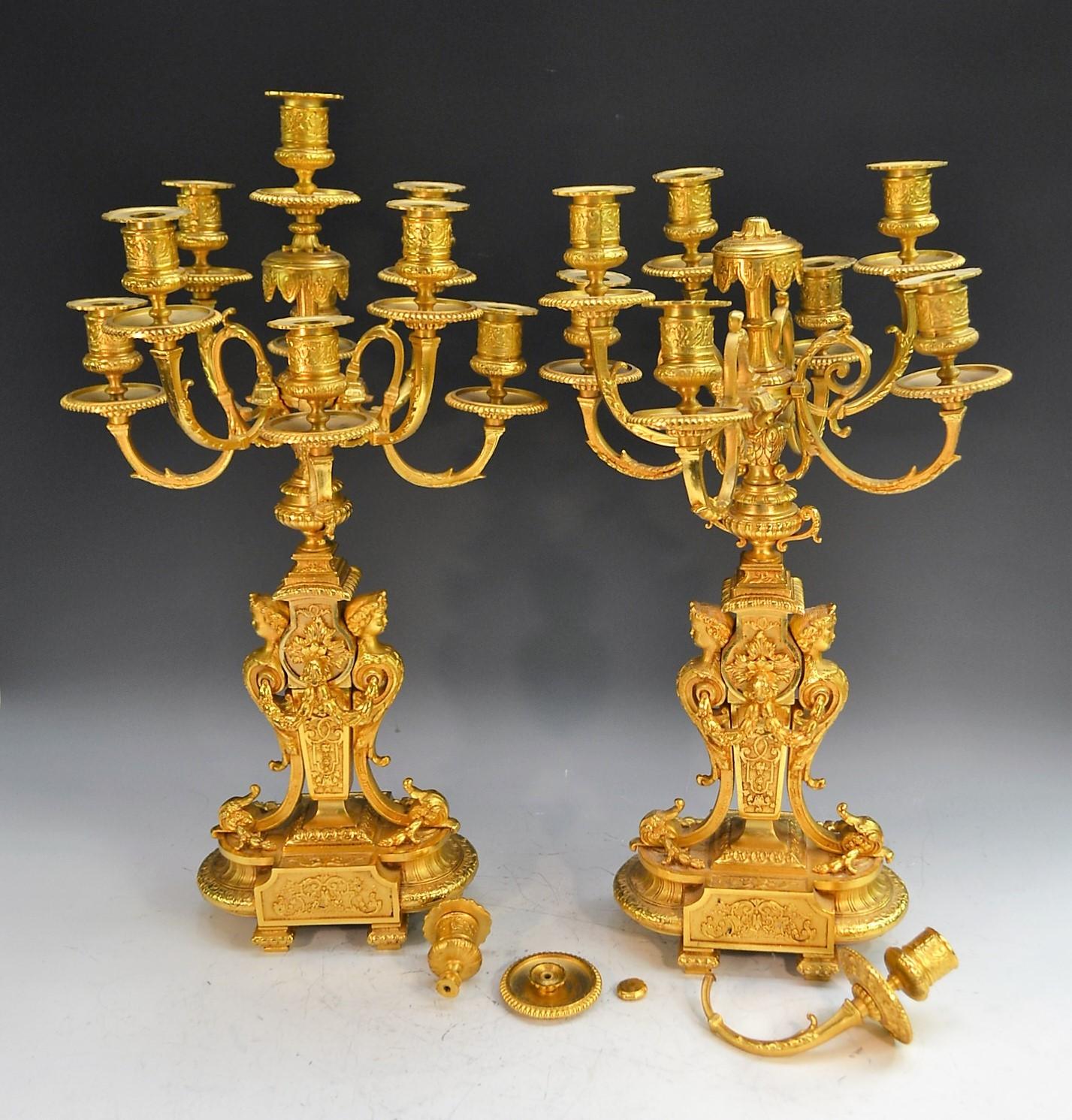 A pair of Louis XVI Revival gilt-metal nine-light table candelabrum, campana sconces, circular