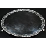 A George III silver shaped circular salver, gadrooned border chased with flowers and scrolling