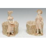 A pair of Royal Worcester figural jardinieres, modelled by James Hadley, of a boy and a girl,
