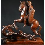 An early 20th century mahogany carving, of St George and the Dragon, he in armour, his horse rearing