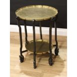 A Chinese hardwood and brass occasional table, the shaped circular plateux chased and engraved