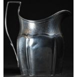 A George III silver oval helmet shaped cream jug, angular scroll handle, bright-cut and