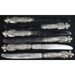 A set of six Chinese silver coloured metal table knives, each haft as an immortal, the blades