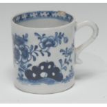 A Lowestoft coffee can, in underglaze blue with trailing flowers and holed rocks, the interior