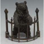 A 19th century Russian brown patinated bronze novelty inkwell, as a bear standing at railings, his