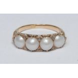 A diamond and pearl line ring, scrolling crest inset with four grey white mabe pearls each divided