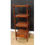 A Regency style mahogany whatnot, each square plateau lined with tan leather, turned finials and