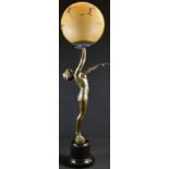 An Art Deco design verdigris patinated figural table lamp, as a scantily clad young lady balancing a