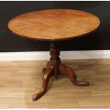 A George III oak tripod occasional table, circular tilting top, turned pillar, cabriole legs, pad