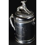 A late 19th century German tankard shaped money box, hinged cover with aperture cover cast as a dog,