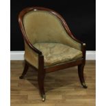A Regency mahogany Bergère library chair, squab cushion, sabre legs, brass casters, c.1820