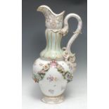 A large 19th century porcelain ewer, encrusted with floral swags and painted with foliage sprigs,