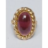 A large pink stone cabochon ring, oval pinky purple cabochon, possibly tourmaline, collar and rope