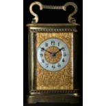 A late 19th century French lacquered brass carriage timepiece, 5cm dial with enamel chapter of