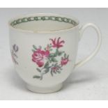 A Pennington Liverpool coffee cup, decorated in polychrome with scattered flowers, loop handle, c.