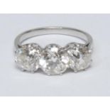 A diamond trilogy ring, central round brilliant cut diamond approx 1.57ct, flanked either side by