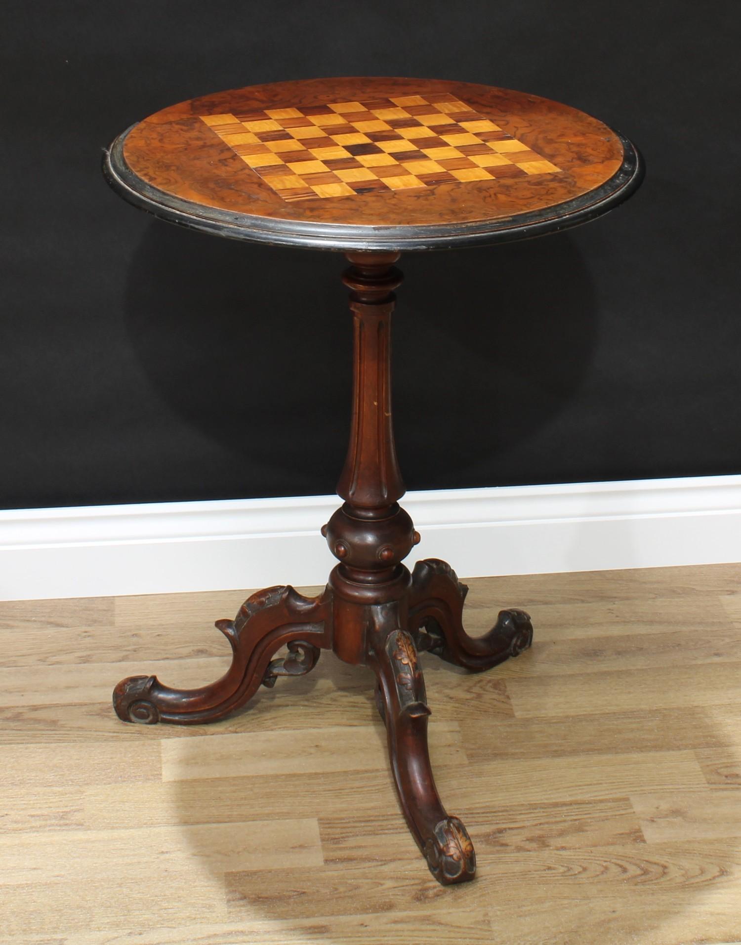 A Victorian walnut tripod games table, circular top inlaid for chess, turned and fluted pillar,