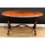 A Victorian burr walnut centre table, oval top with carved edge, pierced cartouche shaped end