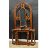 A Victorian oak hall stand, arched back centred by a mirror, the projecting base with marble top
