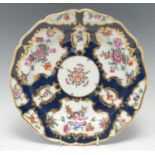 A Worcester shaped circular plate, decorated with fan and vase shaped reserves with flowers and