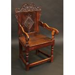 An '18th century' wainscote armchair, shaped cresting above a rectangular back carved with
