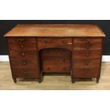 A 19th century mahogany kneehole desk, oversailing rounded rectangular top with shallow three-