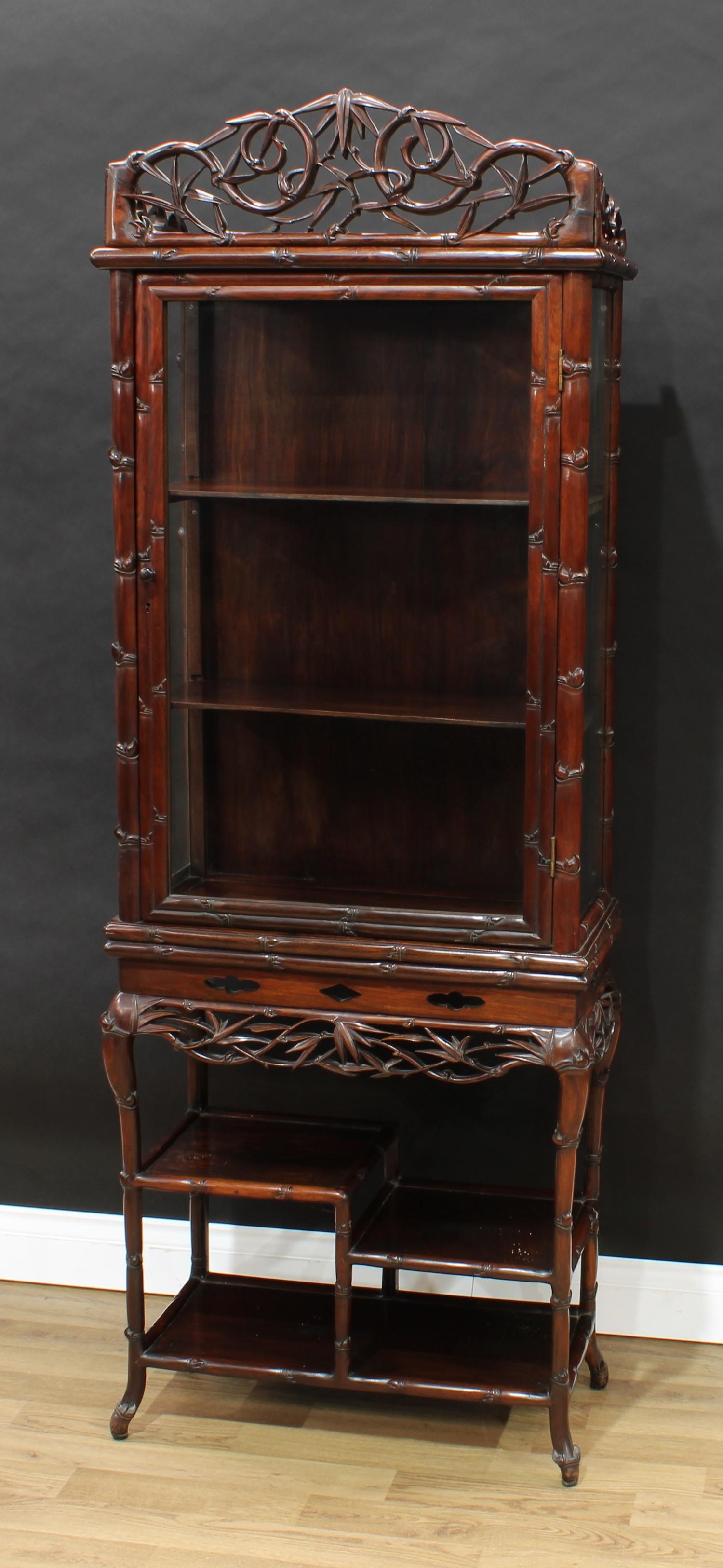 A Chinese hardwood vitrine on stand, shaped cresting above a rectangular door and an asymmetrical - Image 2 of 2