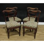 A set of four early Victorian mahogany dining chairs, cartouche shaped backs carved with scrolling