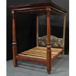 A William IV mahogany four poster bed, outswept cornice, turned posts with carved lotus socles,