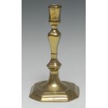 A late 17th century French brass canted square candlestick, 19cm high, c.1690